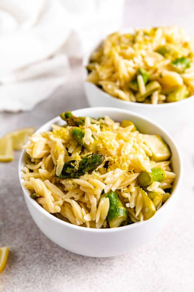 Close up view of orzo with lemon and asparagus.