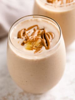 Two glasses of peanut butter banana smoothie.