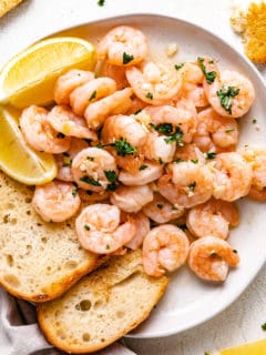 Shrimp scampi and toast on a plate.