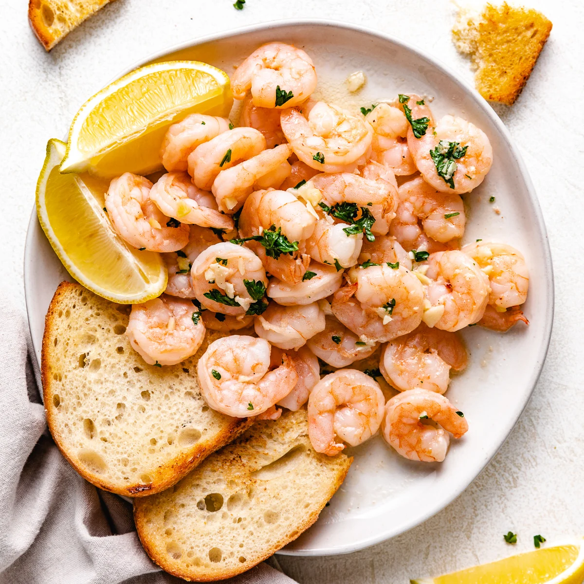 Shrimp scampi and toast on a plate.