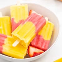 Large bowl filled with fruit popsicles.