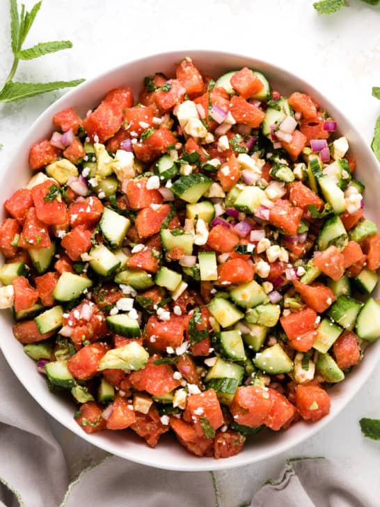 Top down view of a watermelon salad in a bowl.