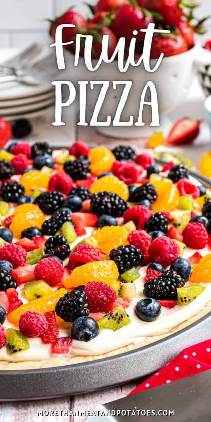 Close up view of a fruit pizza on a pan.