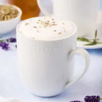 White coffee mug filled with coffee latte.