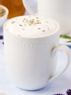 White coffee mug filled with coffee latte.