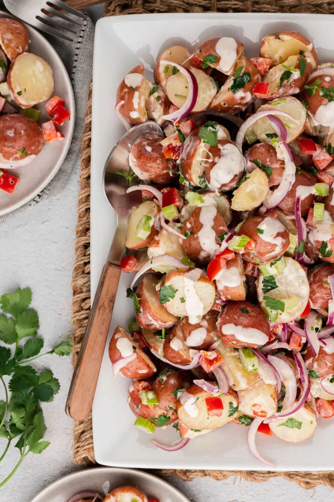 Top down view of creamy potato salad on a dish.