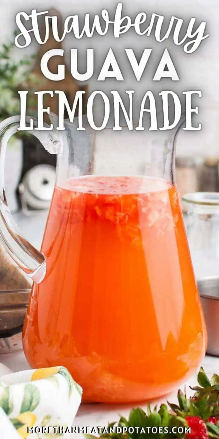 Close up view of a pitcher of strawberry guava lemonade.