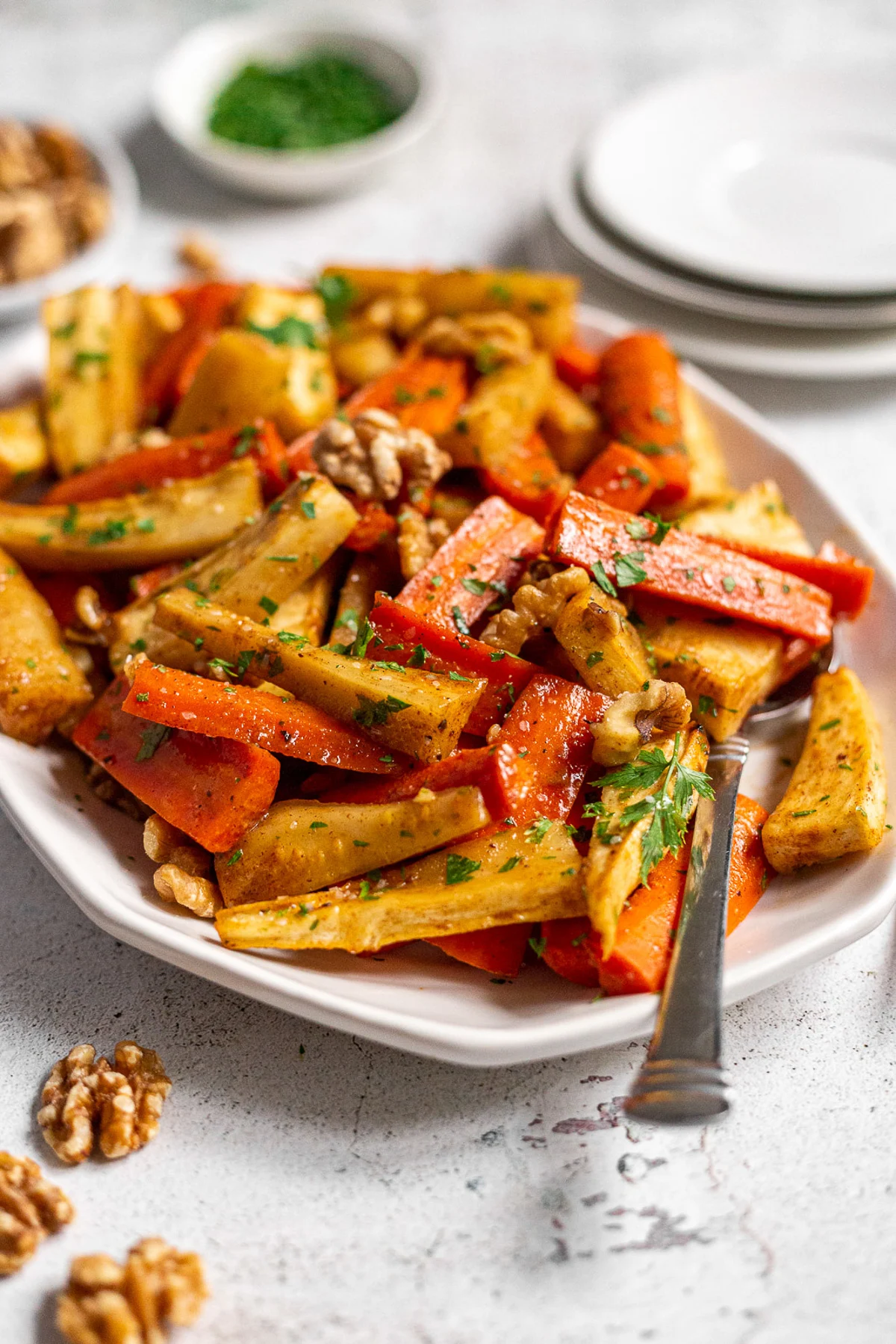 Side view of honey roasted veggies on a serving dish.