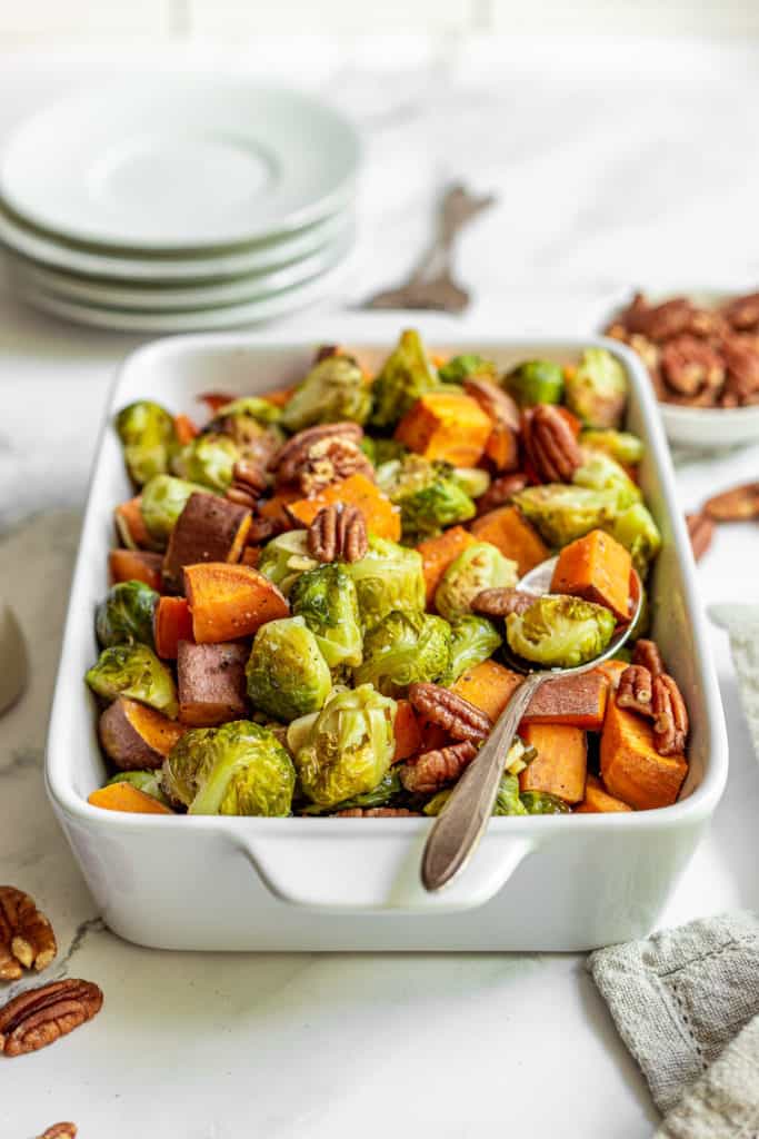 White baking dish filled with roasted vegetables.