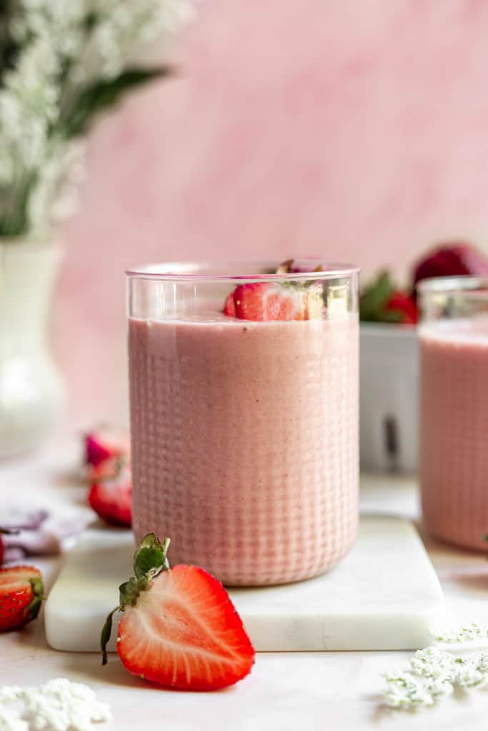 Side view of a strawberry banana peanut butter smoothie.