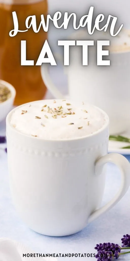 Close up view of a lavender latte in a white mug.