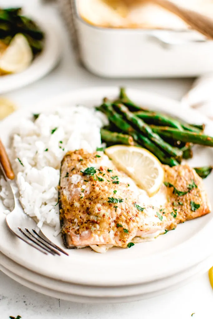 Salmon with a lemon wedge on a plate.