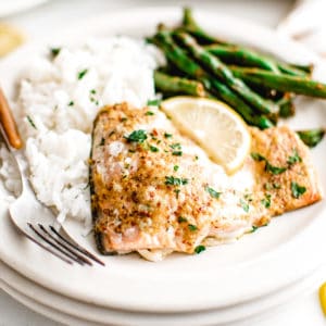 Salmon, green beans and rice on a plate.
