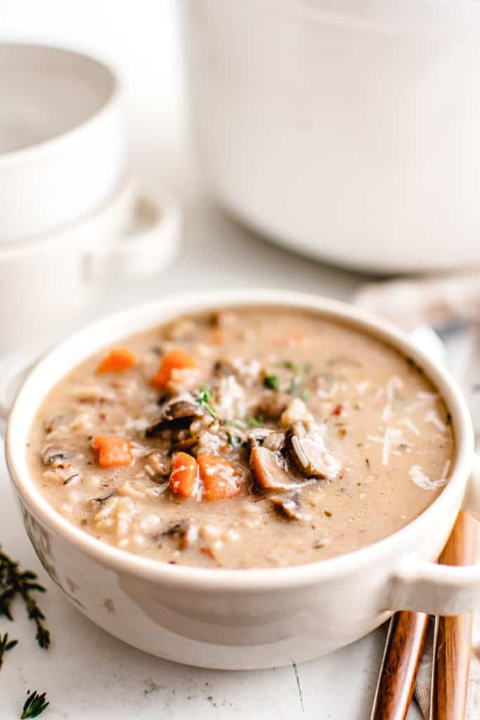 Wild rice soup in a white bowl.