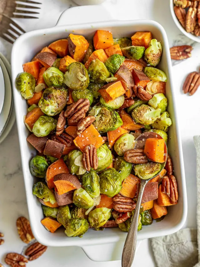 Top down view of brussel sprouts and sweet potatoes in a dish.