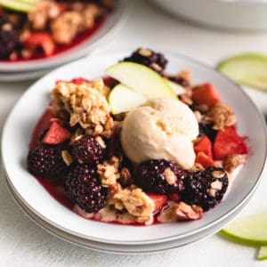 Close up view of a fruit crumble on a plate.