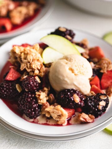 Close up view of a fruit crumble on a plate.