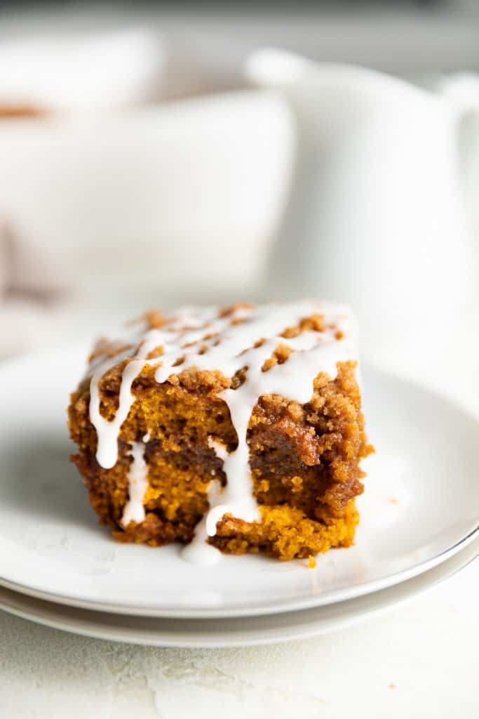 Pumpkin cake with cinnamon and drizzle on a plate.