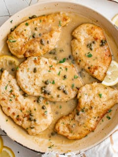 Close up view of chicken piccata in a pan.