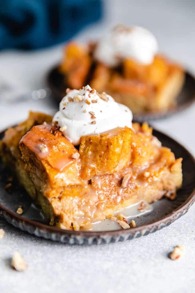 Bread pudding on a plate with rum sauce.