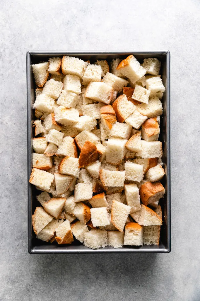 Cubed bread in a pan.