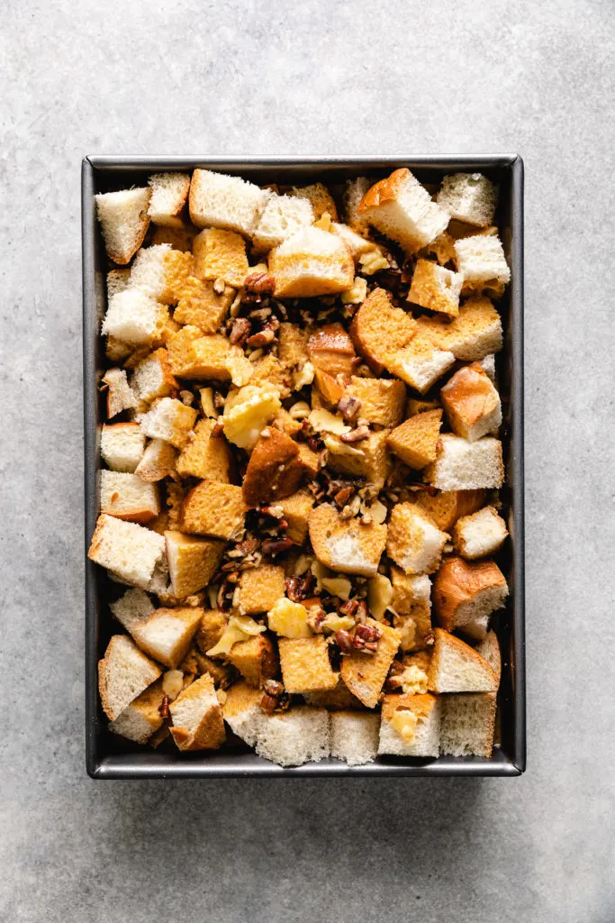 Egg and milk mixture poured over cubed bread.