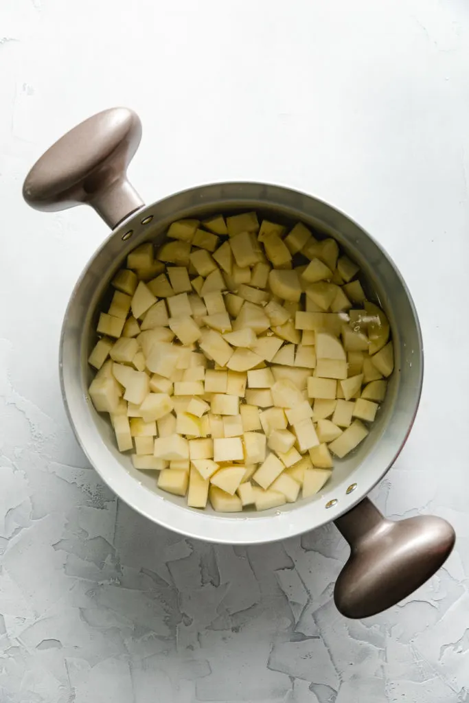 Large pan of water with potatoes.