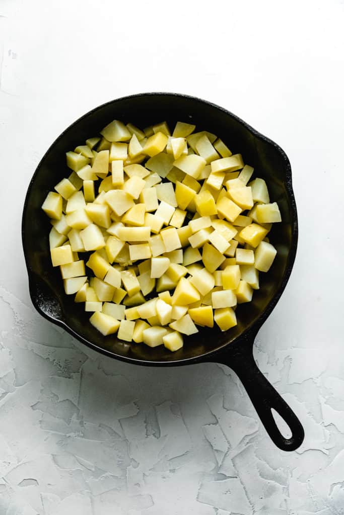 Potatoes in a cast iron skillet.