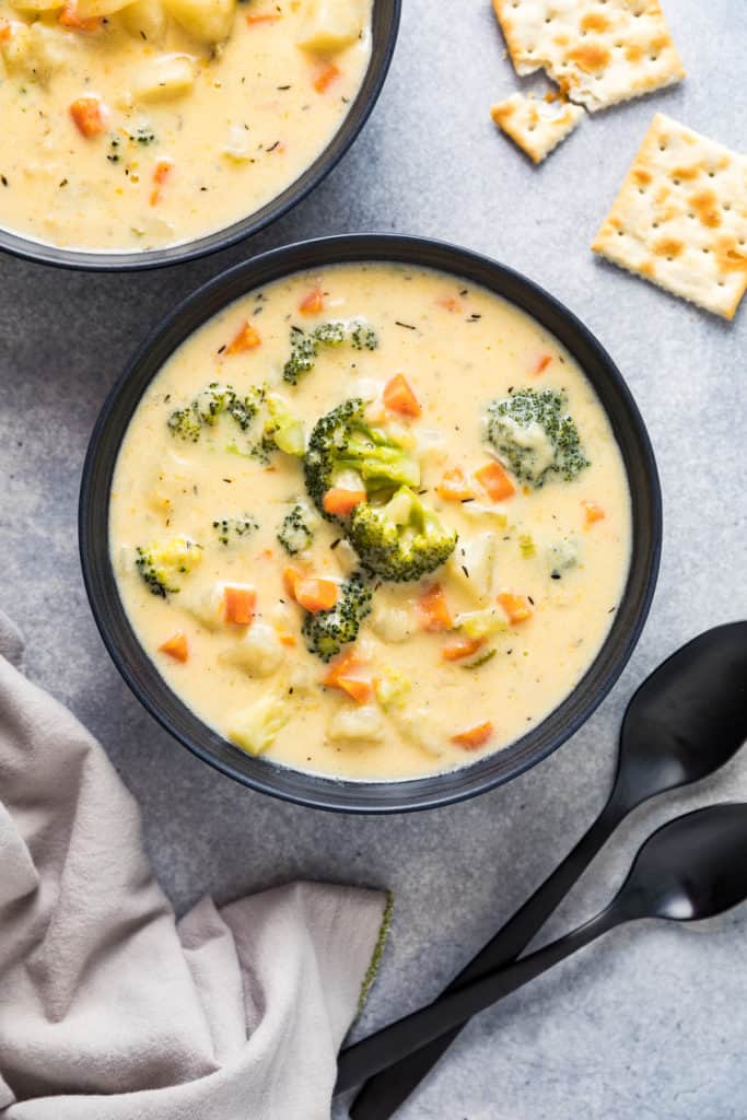 Top down view of broccoli potato cheese soup in bowls.