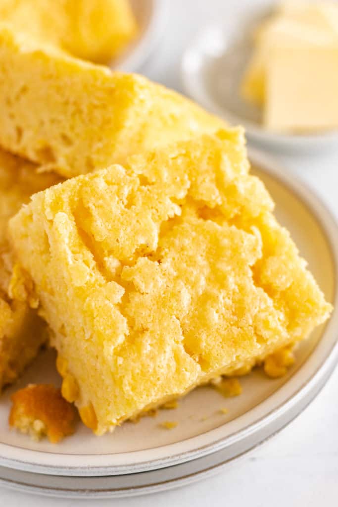 Close up view of cornbread on a plate.