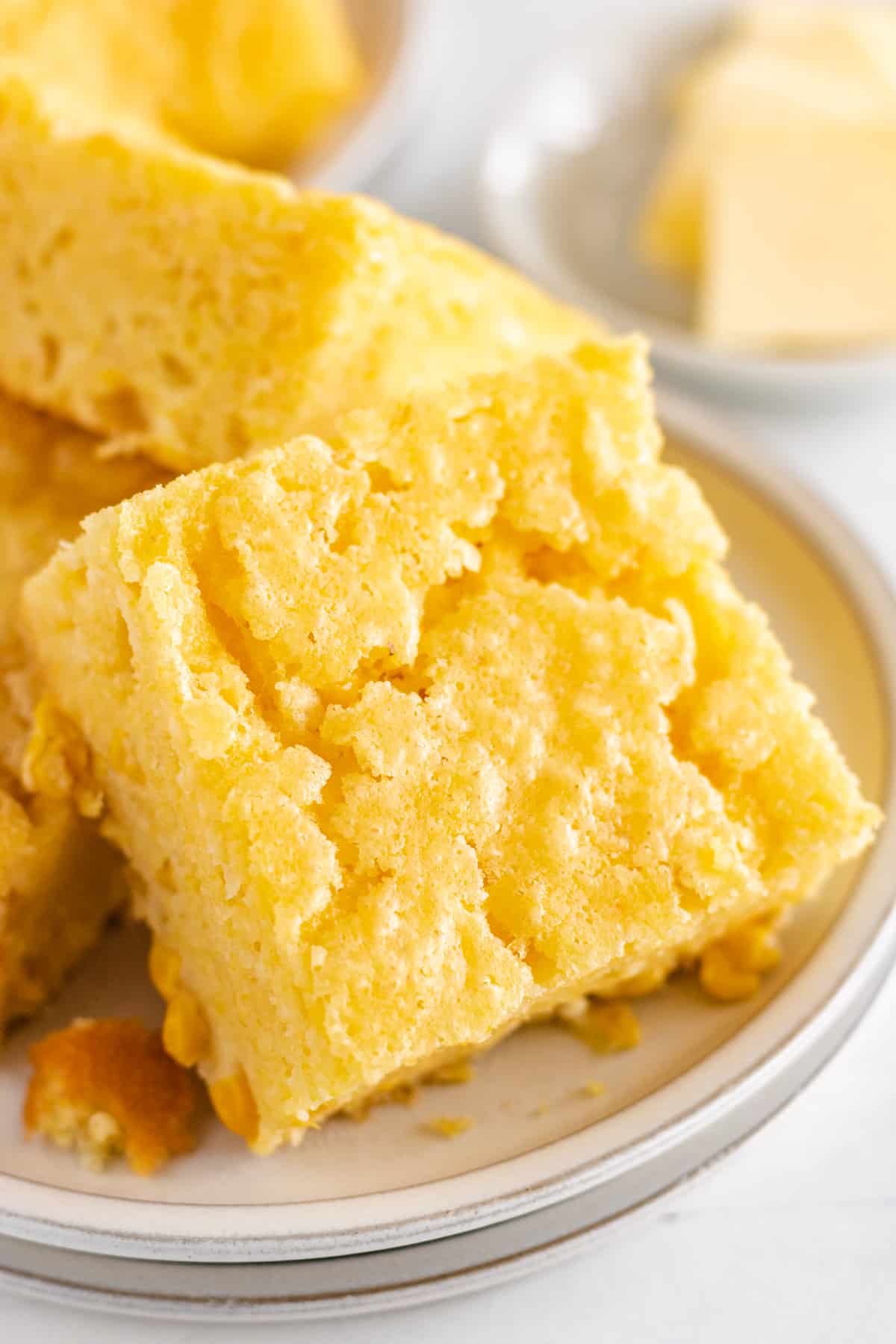 Close up view of cornbread on a plate.