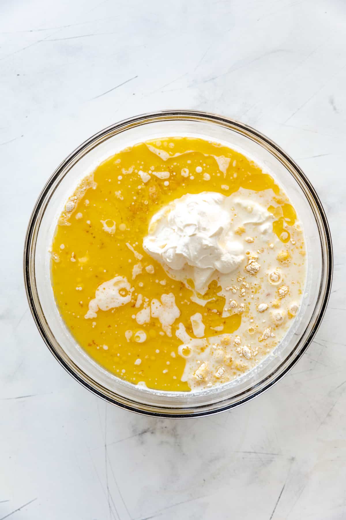 Melted butter, eggs, and sour cream on top of cornmeal and flour.