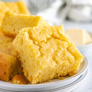 Close up view of cornbread on a plate.