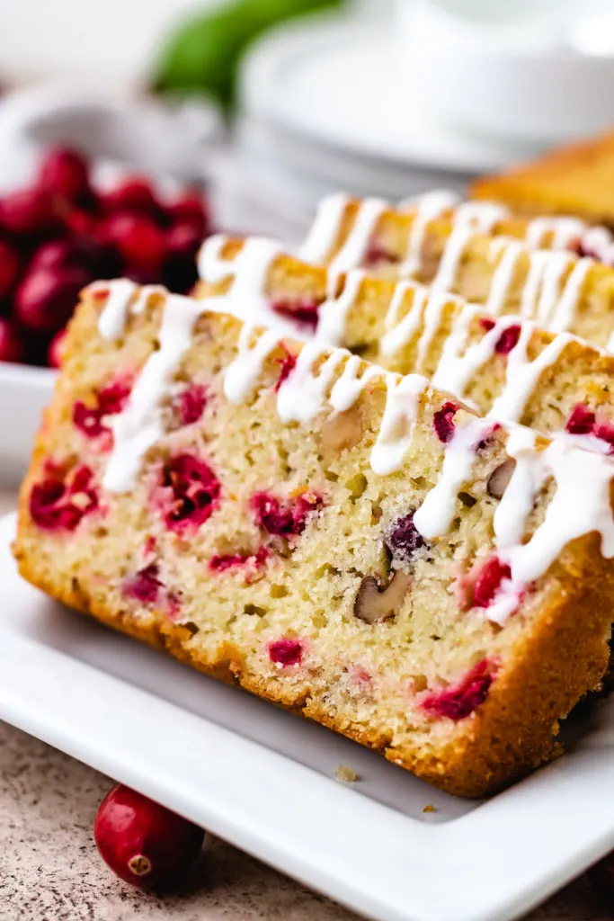 Side view of a loaf of glazed cranberry bread.