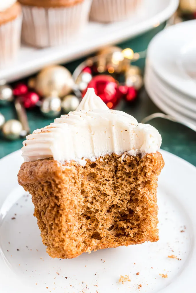 Bite taken out of a gingerbread cupcake.