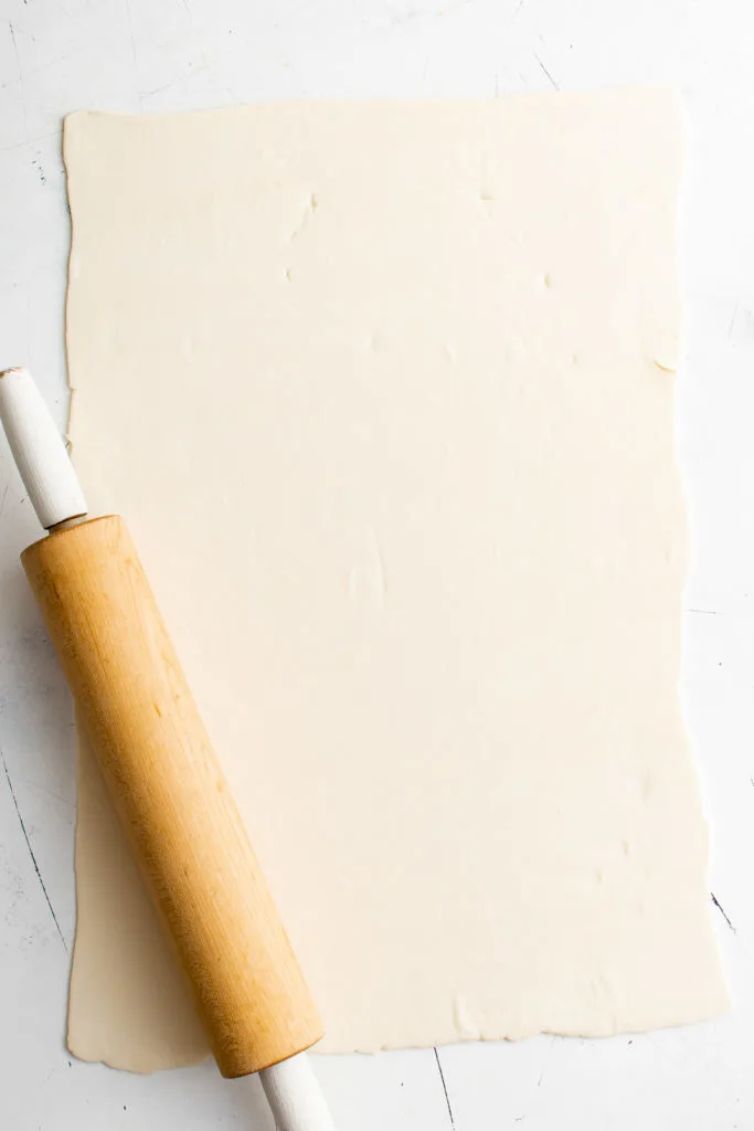 Puff pastry rolled out with a rolling pin.