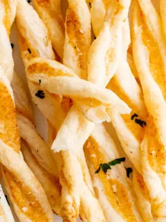 Close up view of cheese straws made from puff pastry.