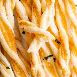 Close up view of cheese straws made from puff pastry.