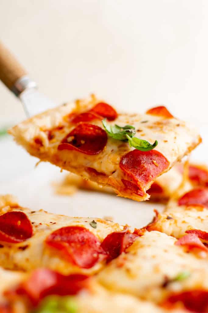 Slice of pizza on a spatula.