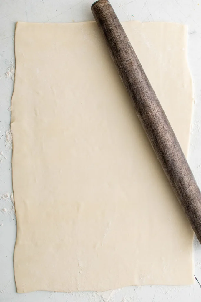 Puff pastry with a rolling pin.