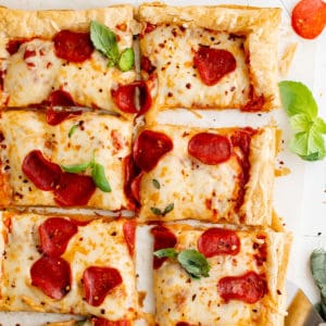 Top down view of puff pastry pizza with pepperoni.