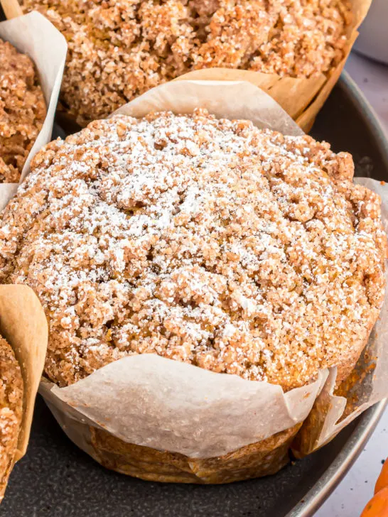 Close up view of a pumpkin muffin with streusel topping.