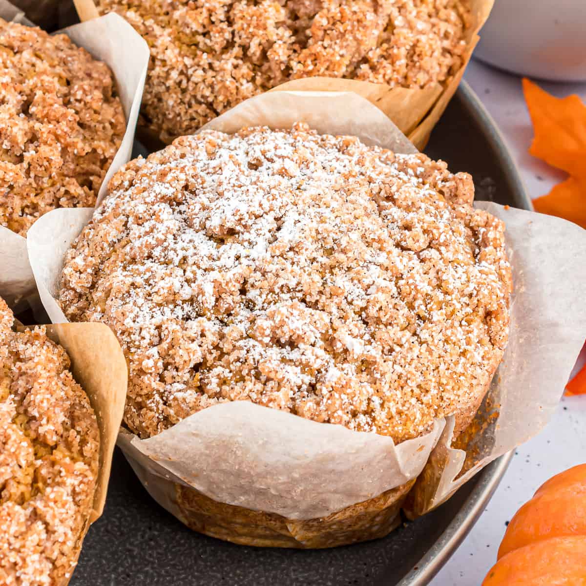 Close up view of a pumpkin muffin with streusel topping.