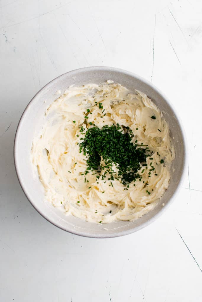 Chives in a bowl of butter.