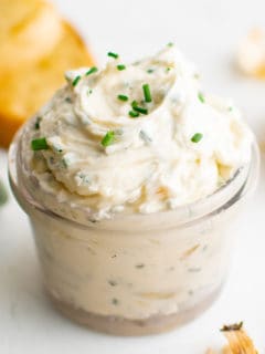Roasted garlic butter in a small glass jar.