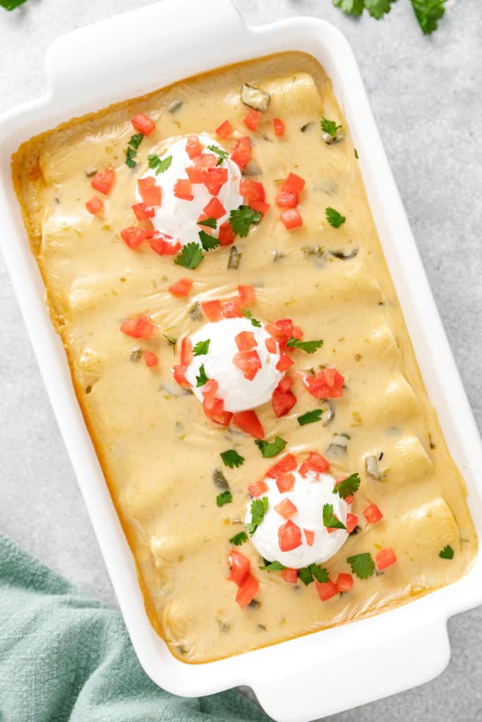 Top down view of beef enchiladas in a pan.