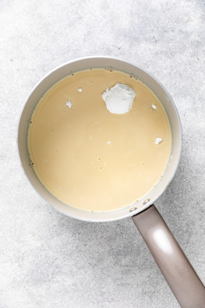 Evaporated milk and cornstarch in a pan.