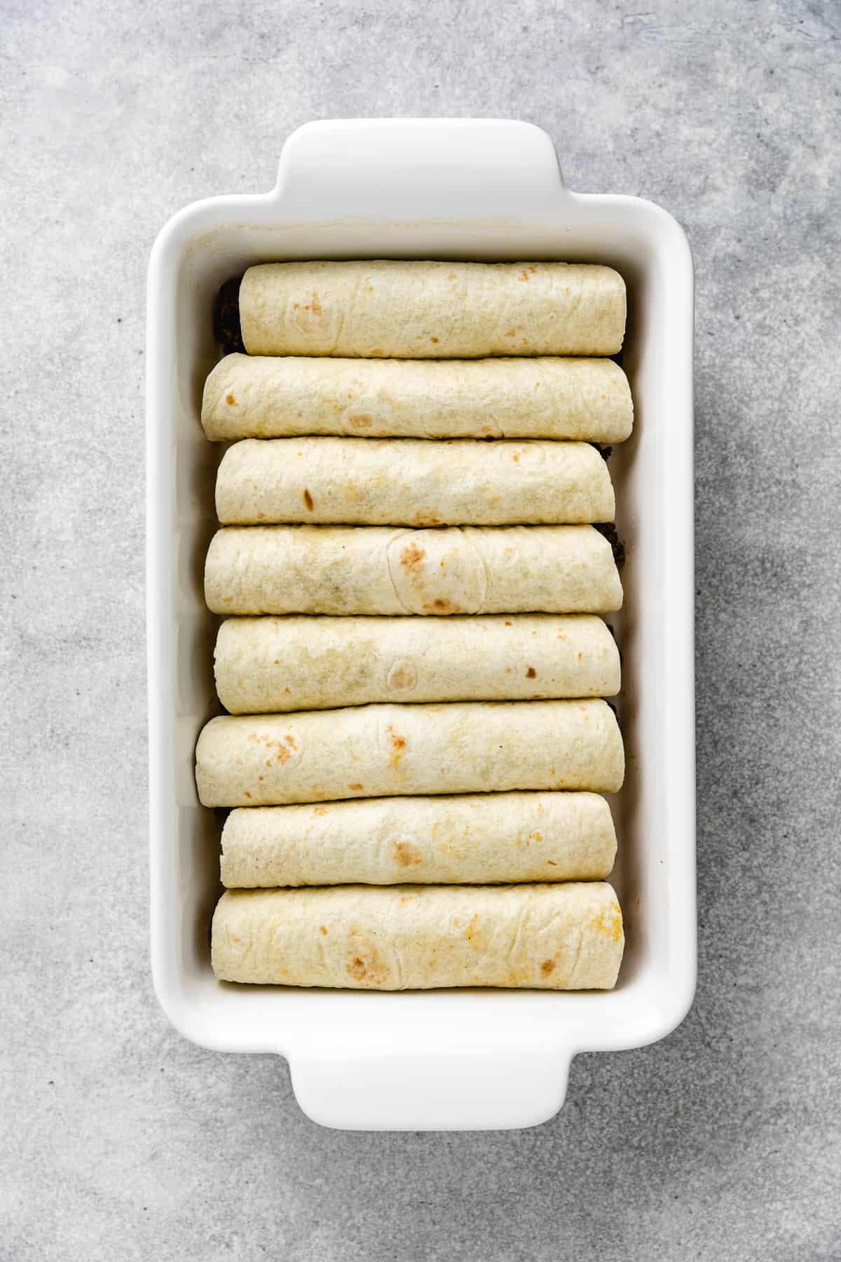 Enchiladas in a baking pan.