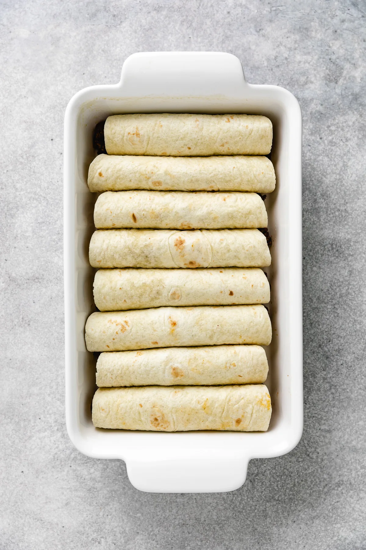 Enchiladas in a baking pan.