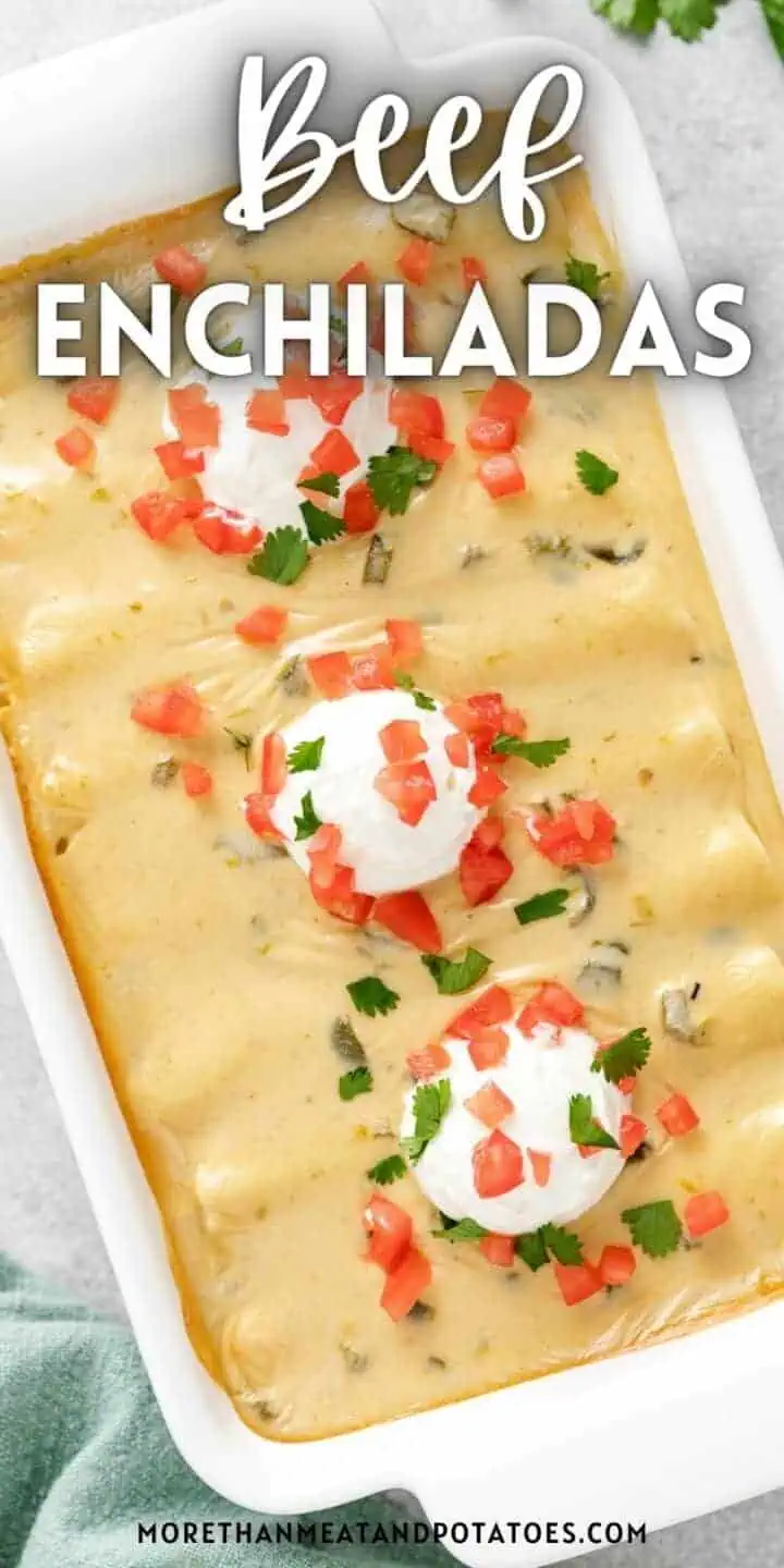 Top down view of beef enchiladas in a white pan.